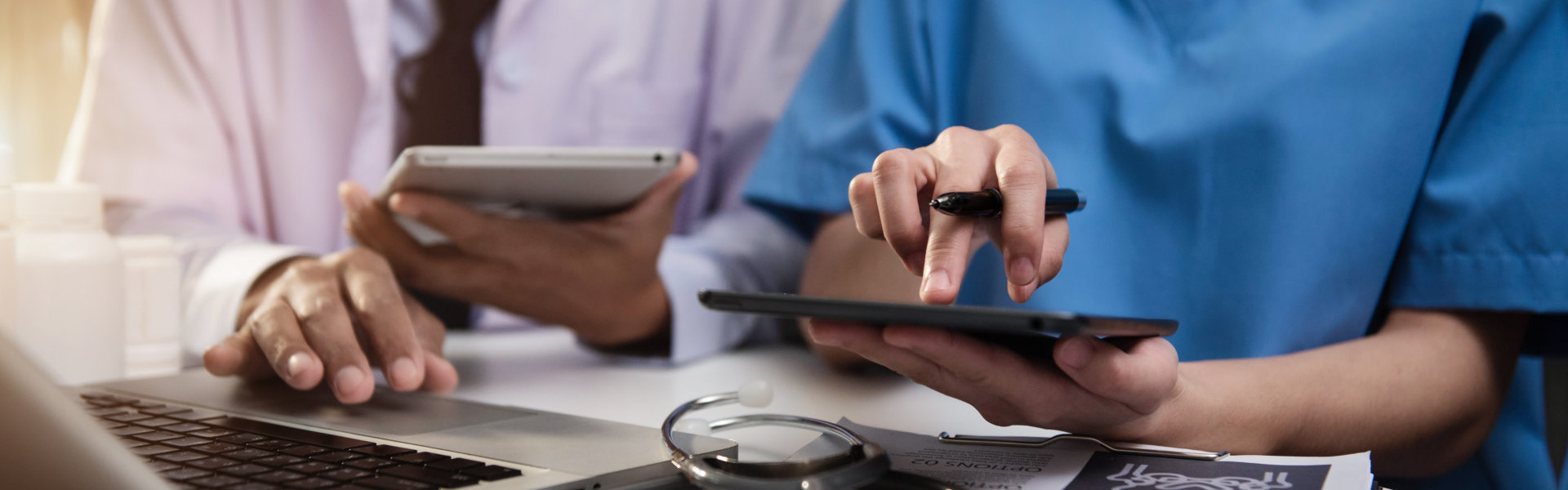 Doctors working together on digital tablet healthcare doctor technology tablet using computer in a modern office.